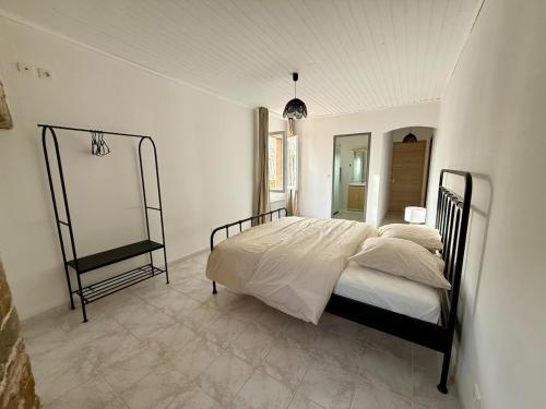 a bedroom with a bed and a mirror on the wall at Gîte 2 suites proche du lac de Chalain in Montigny-sur-lʼAin
