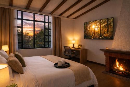 a hotel room with a bed and a fireplace at Durán Business Suites near Airport in Bogotá