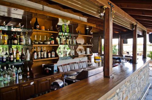 a bar with a lot of bottles on the wall at Seralis Pelion in Afissos