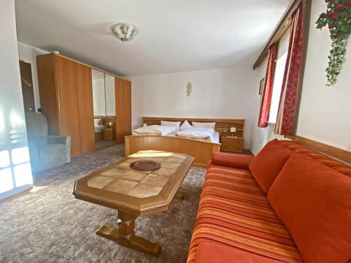 a living room with a couch and a table at Bauernhof Daurerhof Ferienwohnung in Aschau im Chiemgau