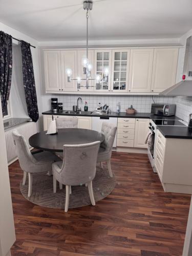 a kitchen with a table and chairs in it at Asken 8 in Klippan