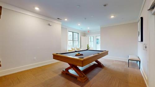 a billiard table in a room with a wall at Modern Comforts Free Gym Access in Stamford