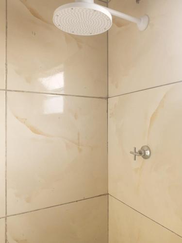 a bathroom with a shower with a glass door at Próximo do carnaval em Olinda in Olinda