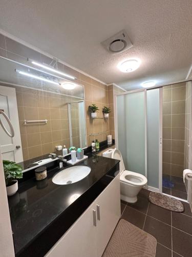 a bathroom with a sink and a toilet and a mirror at CJ Premier Stays at Amalfi Oasis Near SM Seaside Mall & Nustar Casino Hotel, Cebu City in Cebu City