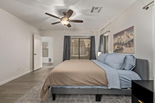 a bedroom with a bed and a ceiling fan at West Valley Pool Side Oasis in Surprise