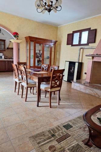 a dining room with a table and chairs and a fireplace at Apartment Manna Hof by Interhome in Irgoli