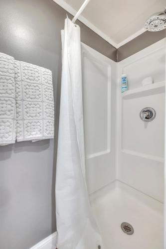 a bathroom with a shower with white towels at 127 Hwy 71 AT Bunk House in Arnolds Park