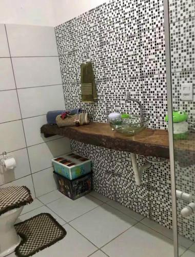a bathroom with a sink and a mirror on a counter at Relax Private Room - Santo André, BA in Santo André
