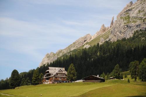 a house on a hill in front of a mountain at Hohe Gaisl in Braies