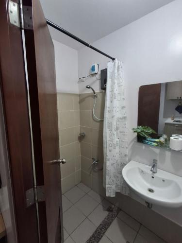 a bathroom with a shower and a sink at Casa Aurora in Mandaue City