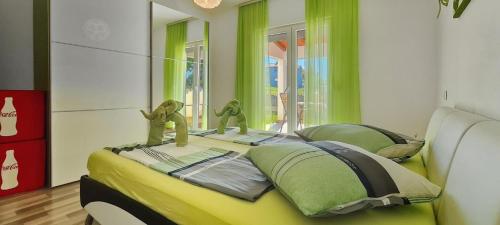 a bedroom with a bed with two puppets on it at Villa Kasandra - Ruhe & Eleganz in Buje, Istrien in Kaštel
