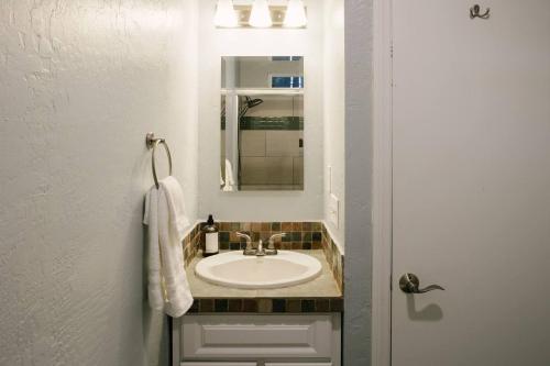 a bathroom with a sink and a mirror at Peaceful Mountain Sanctuary near Arrowhead Village in Lake Arrowhead