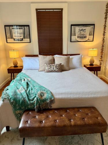 a bedroom with a large bed and two lamps at Couples Cottage with Hot Tub in Mathews