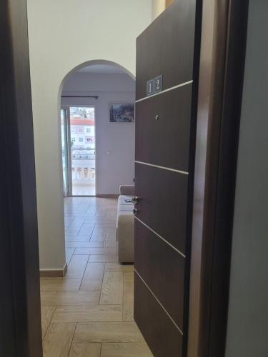 a door to a hallway with a room at Saranda Promenade Studio Apartment in Sarandë