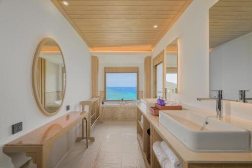 a bathroom with two sinks and a large window at Centara Villas Phi Phi Island in Phi Phi Islands