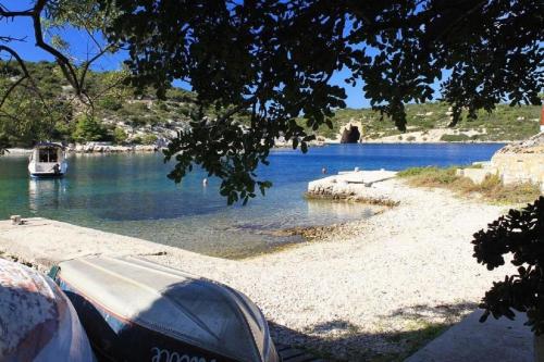 a boat sitting on the shore of a lake at House Paulo2 in Rogačić