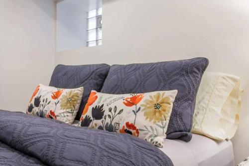 a blue couch with pillows on top of it at The Wrigleyville Garden 200 Steps to Wrigley-2BR in Chicago