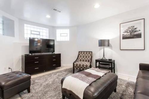 a living room with a bed and a tv at The Wrigleyville Garden 200 Steps to Wrigley-2BR in Chicago