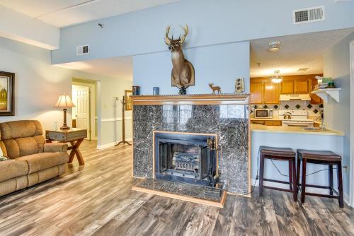a living room with a fireplace and a couch at Less Than 4 Mi to Sugar Mtn Resort Condo with Indoor Pool! in Sugar Mountain