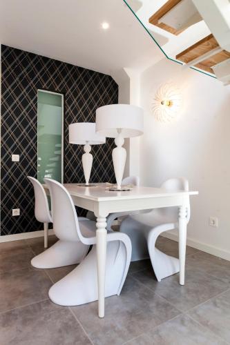 a dining room with a white table and chairs at El Mirador Del Alcazar in Segovia