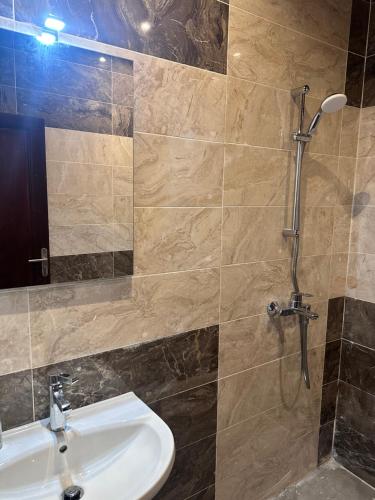 a bathroom with a sink and a shower at Résidence Prestige KGV Appt 303 in Douala