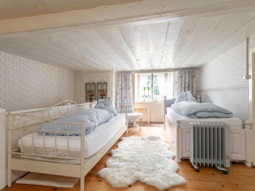a bedroom with two beds and a window at Waldhüsle in Dalaas
