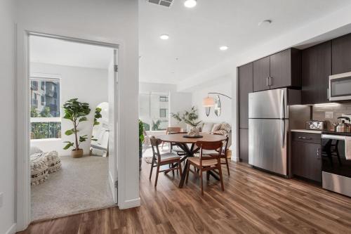 a kitchen and dining room with a table and a refrigerator at Luxury 1BDR centrally located in Hollywood in Los Angeles