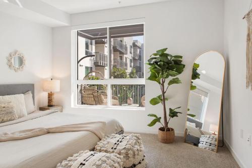 a bedroom with a bed and a large window at Luxury 1BDR centrally located in Hollywood in Los Angeles