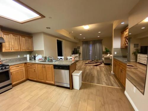 a large kitchen with wooden cabinets and a counter top at Modern 2BD Apartment with 2 Baths in Alhambra in Alhambra