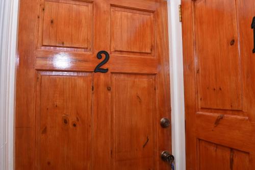 a wooden door with the number two on it at Duncan Street Guesthouse in Georgetown