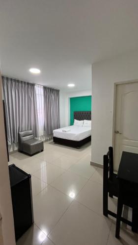 a large bedroom with a bed and a couch at Hostal Bali - Talara in Talara