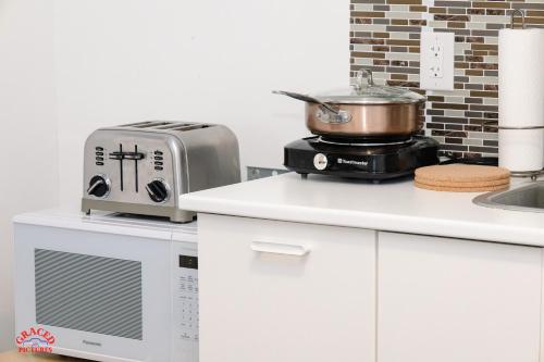 a kitchen with a toaster and a toaster and a microwave at ChrisTon Exotic Suite - A Homey Suite in Halifax