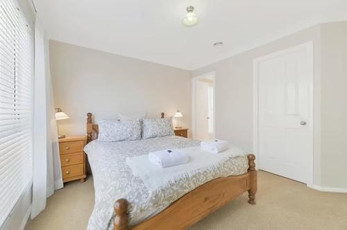 a bedroom with a bed with two towels on it at Prime on Piper in Bathurst