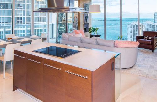 a kitchen with an island in a living room at Brickell by Miami Vacation Rentals in Miami