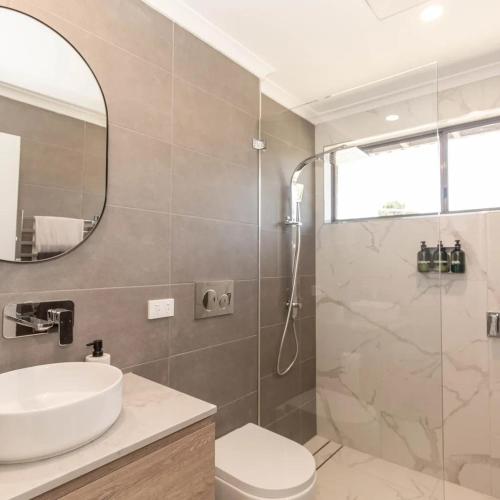 a bathroom with a sink and a shower at Lakeside Breeze in Jindabyne