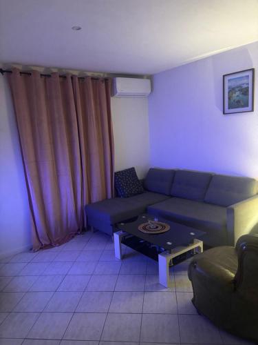 a living room with a couch and a table at Logement catalan in Perpignan