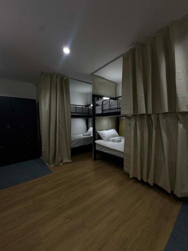 a room with two bunk beds and a wooden floor at Top Residence Patong in Patong Beach