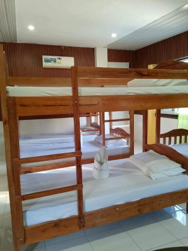 a group of bunk beds in a room at MJ's Guesthouse in Tubod