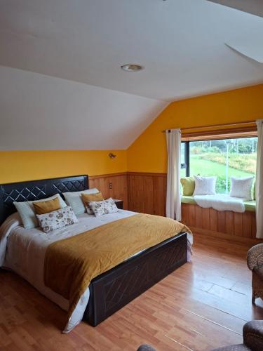 a bedroom with a large bed and a window at Vista volcanes house in Puerto Varas