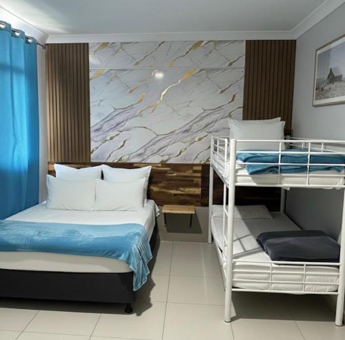 a bedroom with two bunk beds and a mural at Perth City Motel in Perth