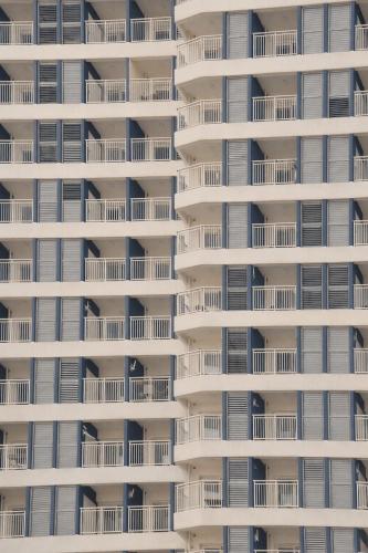 a tall white apartment building with white balconies at Yangyang Cohost Studio in Yangyang