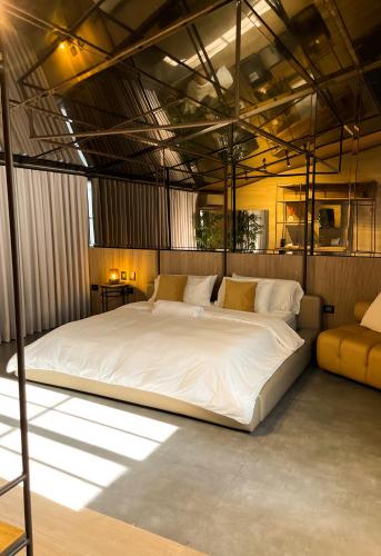 a bedroom with a large white bed in a room at Cuna 58 in Barranquilla