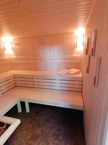 a sauna with a bench in a wooden room at Parkhotel Ropeter in Göttingen