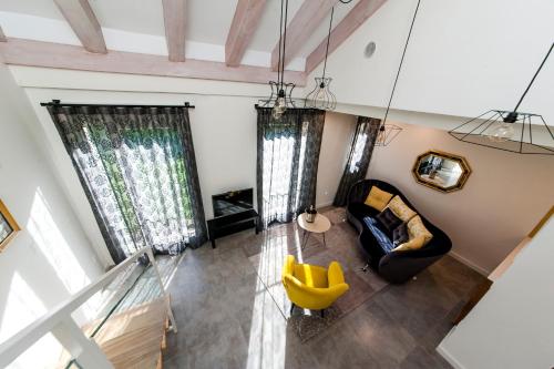 an overhead view of a living room with a yellow chair at El Mirador Del Alcazar in Segovia