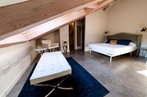 a bedroom with a bed and a couch in a room at El Mirador Del Alcazar in Segovia
