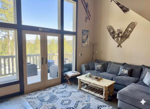 a living room with a couch and a table at Kirkwood Mountainside Cabin & Cottage Deck wViews in Kirkwood