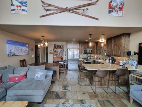 a living room and kitchen with a couch and a table at Kirkwood Mountainside Cabin & Cottage Deck wViews in Kirkwood
