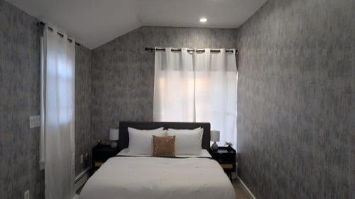 a bedroom with a bed and a window at Private, Spacious & Comfy 1 bedroom Entire Suite With Separate Entry & Free Parking in Holbrook
