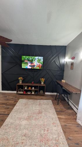 a living room with a flat screen tv on a wall at Private, Spacious & Comfy 1 bedroom Entire Suite With Separate Entry & Free Parking in Holbrook
