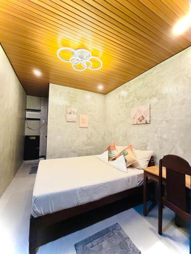 a bedroom with a bed and a ceiling with a ceiling fan at Astra Tourist Inn near Airport with high speed free Wifi in Puerto Princesa City